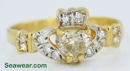 heart diamond in yellow prongs with rhodium plated Claddagh hands
